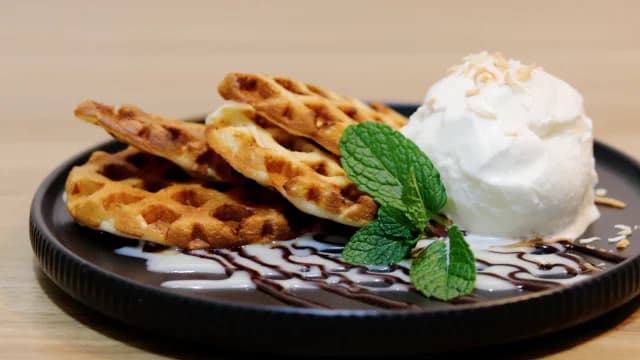 Waffles served with ice cream and mint.