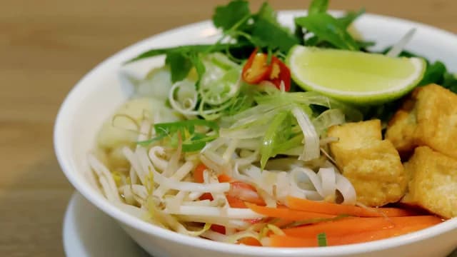 Noodle soup with tofu, herbs, and lime.