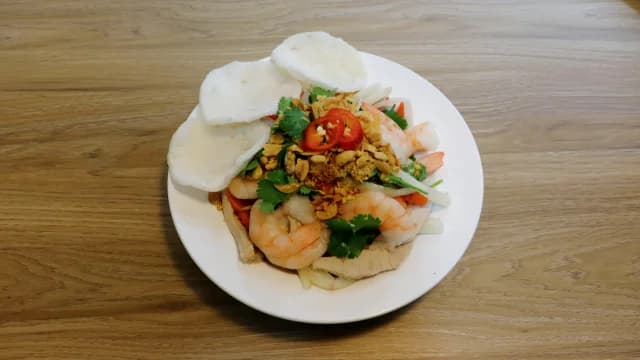 A colourful salad with herbs and crisp crackers.
